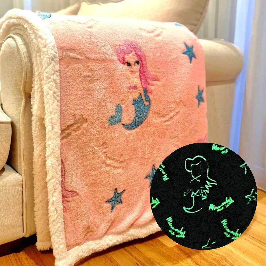 Pink mermaid blanket folded over a couch
